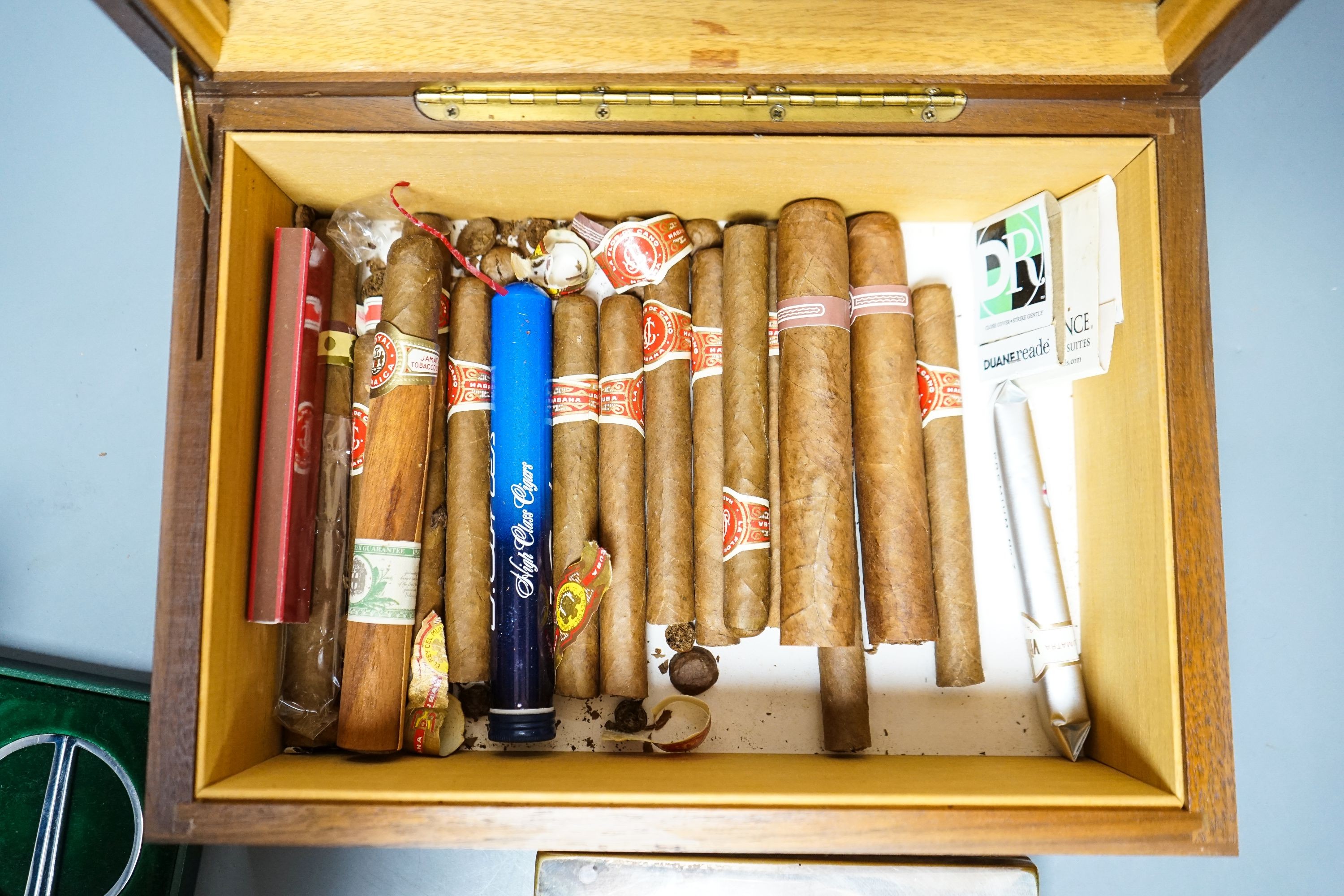 A cased Davidoff cigar cutter, walnut humidor, plated cigarette box, various cigars etc.
